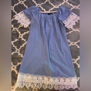 blue and white dress with lace detailing on the bottom and sleeves